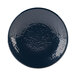 A close-up of the textured blue surface of an Elite Global Solutions Pebble Creek Lapis-Colored round plate.