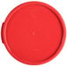 A red Carlisle round polypropylene food storage container lid.