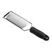A stainless steel ribbon grater with a black ergonomic handle.