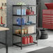 A black metal 5-shelf boltless wire shelving unit with various garage supplies stored on it.