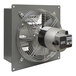 A close-up of a Canarm standard metal wall exhaust fan with a small round fan.