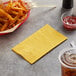 a bowl of french fries and a yellow napkin next to a yellow napkin