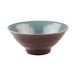 A close-up of an Elite Global Solutions Pebble Creek bowl with a light blue rim.