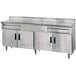 A stainless steel Advance Tabco kitchen work table with drawers.