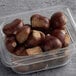 A plastic container filled with Artion whole chestnuts.