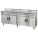 A stainless steel Advance Tabco work table with 3 drawers.