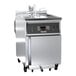 A large stainless steel Giles liquid propane kettle fryer.