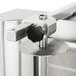 A stainless steel door with a black knob on a Visvardis gyro machine.