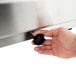 A hand holding a black knob on a Visvardis gas gyro machine.