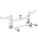 A chrome Equip by T&S deck-mounted faucet with wrist handles and a swing spout.