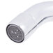 A close-up of a white Equip by T&S deck-mounted faucet with wrist handles.