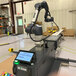 A RG Group QueBot D robotic palletizer in a factory.