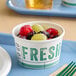 A bowl of fruit in an Innopak To Go Fresh paper food cup.