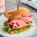 A sandwich with Hebrew National beef bologna and cheese on a plate.