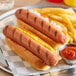 Two Hebrew National beef hot dogs with ketchup and mustard on a plate.