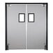 An Aleco Fieldstone Gray rigid swinging traffic door with two white rectangular windows with black frames.