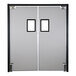 An Aleco Fieldstone Gray rigid traffic door with dual pane rectangular windows with black frames.