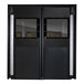 A black double swinging traffic door with glass windows.