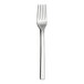 A close-up of a WNK Chatsworth stainless steel dinner fork with a white handle.