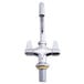 A close-up of a silver Equip by T&amp;S deck-mount faucet with lever handles and a swing nozzle.