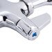 A chrome Equip by T&S deck-mount faucet with lever handles and a swing nozzle.