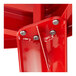A close-up of the red metal base for a Lancaster Table & Seating outdoor table.