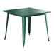 A Lancaster Table & Seating emerald green metal table with four legs.