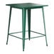 A Lancaster Table & Seating emerald green metal bar height table with a square top.