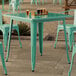 A Lancaster Table & Seating outdoor table and chairs on a patio.