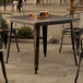 A Lancaster Table & Seating outdoor table with glasses of beer on it.