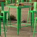A Lancaster Table & Seating jade green bar table on an outdoor patio.