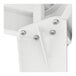 A close-up of a white metal piece with screws from a Lancaster Table & Seating outdoor table.