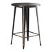 A black metal Lancaster Table & Seating bar table with a distressed copper top.