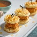 A stack of waffles topped with chicken and Hometown Provisions Clover Honey.