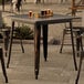 A Lancaster Table & Seating outdoor table with glasses of beer on it.
