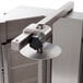 A stainless steel door with a black knob on a Visvardis gyro machine.