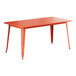 A Lancaster Table & Seating amber orange rectangular table with metal legs.