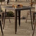 A Lancaster Table & Seating copper outdoor table with drinks on it.
