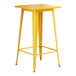 A Lancaster Table & Seating yellow metal bar height table with a square top.