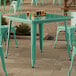 A Lancaster Table & Seating outdoor table and chairs on a patio.