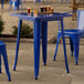 A blue table with legs and glasses on top.