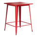 A red metal Lancaster Table & Seating bar height table with a square top and legs.
