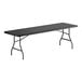 A large black heavy-duty blow molded plastic folding table with black metal legs.