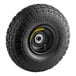 A black tire with a yellow metal wheel.