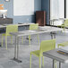 An 18-inch by 72-inch gray heavy-duty blow molded plastic folding table with gray legs, set up in a classroom setting.