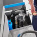 A Shortening Shuttle BOSS battery-operated waste oil transporter with a pump.
