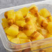 A plastic container of Pitaya Foods IQF Organic Ginger Lime Turmeric Wellness Cubes.