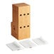 A wooden box with holes and white plastic bags holding World Centric cutlery sleeves.