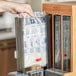 A hand holding a World Centric TPLA Fork refill sleeve