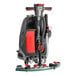 A NaceCare Solutions TGB 817NX floor scrubber with a red and black handle.